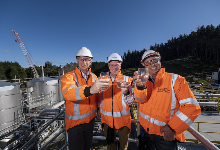 Three Watercare staff drinking water in front of our new Tuakau plant